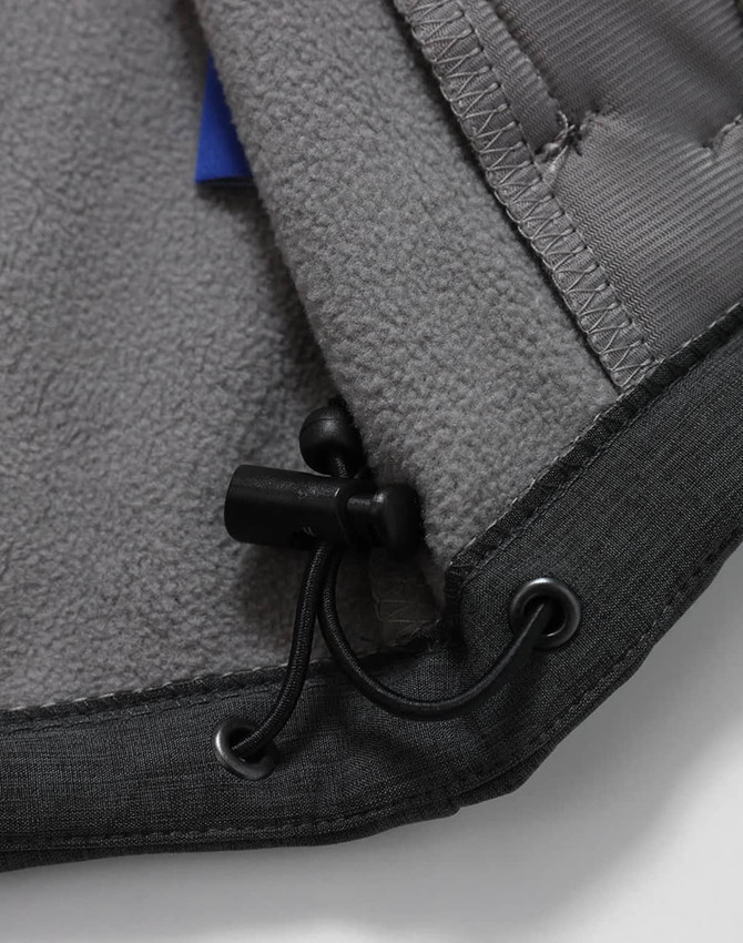 A close-up of the interior of a grey men's softshell full zip hoodie, featuring a drawstring and soft fabric lining.
