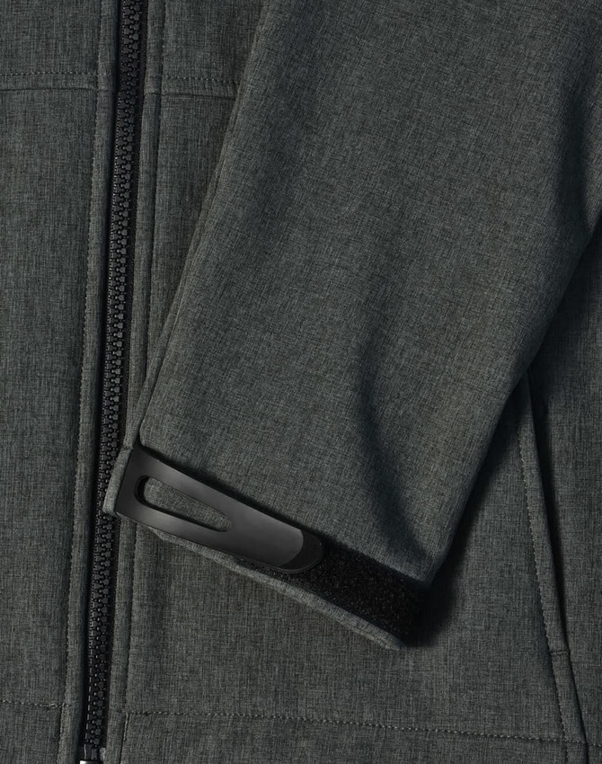 A close-up of a dark grey softshell hoodie highlighting the sleeve cuff with a Velcro adjustment and zipper.