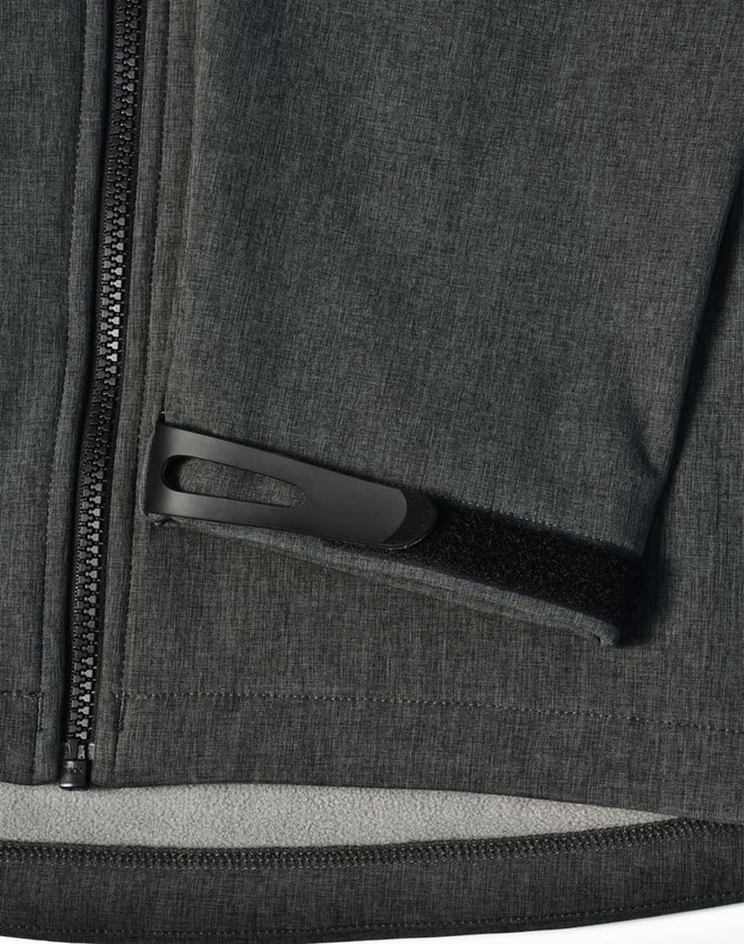 A grey ladies' softshell full zip hoodie featuring a zippered pocket and a logo.