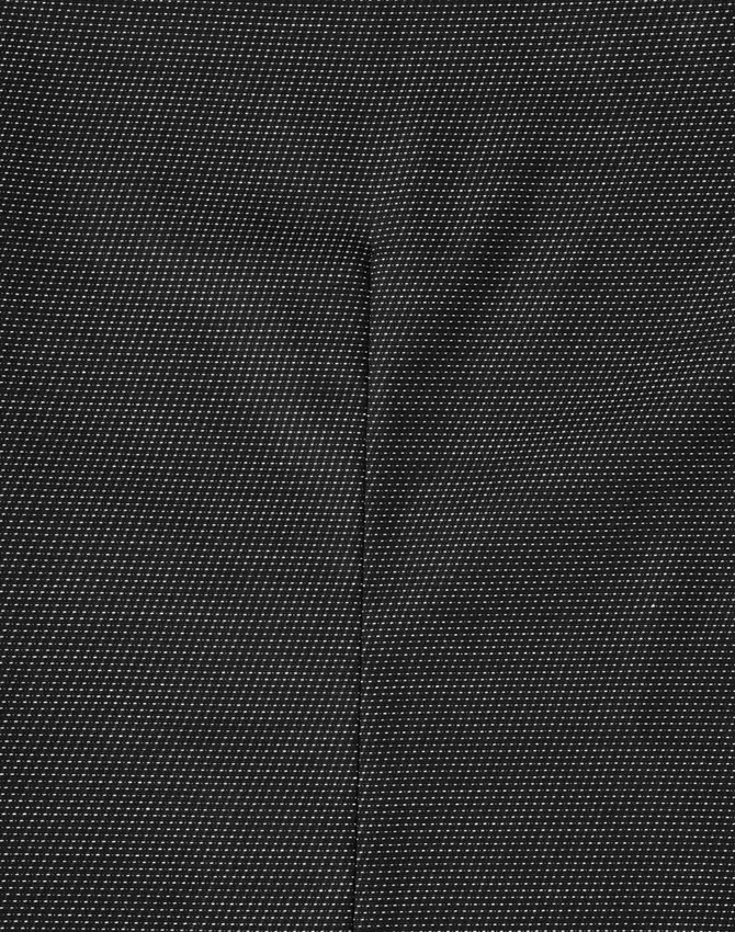 A close-up of a black pin dot patterned fabric, highlighting the texture and detail of the material.
