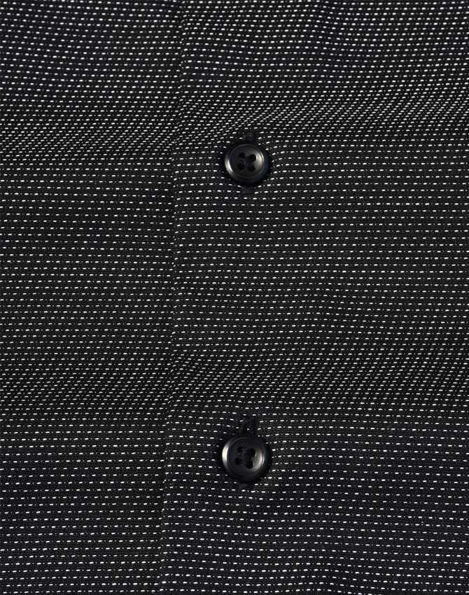 A black button-up shirt featuring a pin dot pattern and two buttons visible on the front. It has a logo.