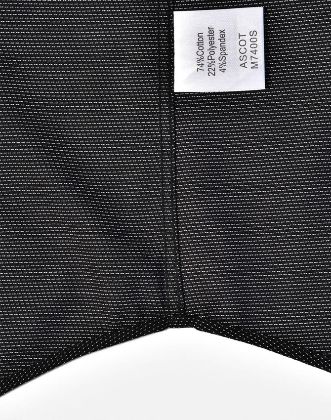 A black pin dot stretch short-sleeve shirt with a care label and a subtle pattern. Features a logo on the label.