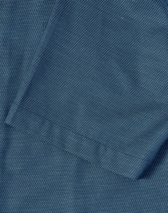 A close-up of a men's short-sleeve button-up shirt in a dark teal colour with a pin dot pattern.