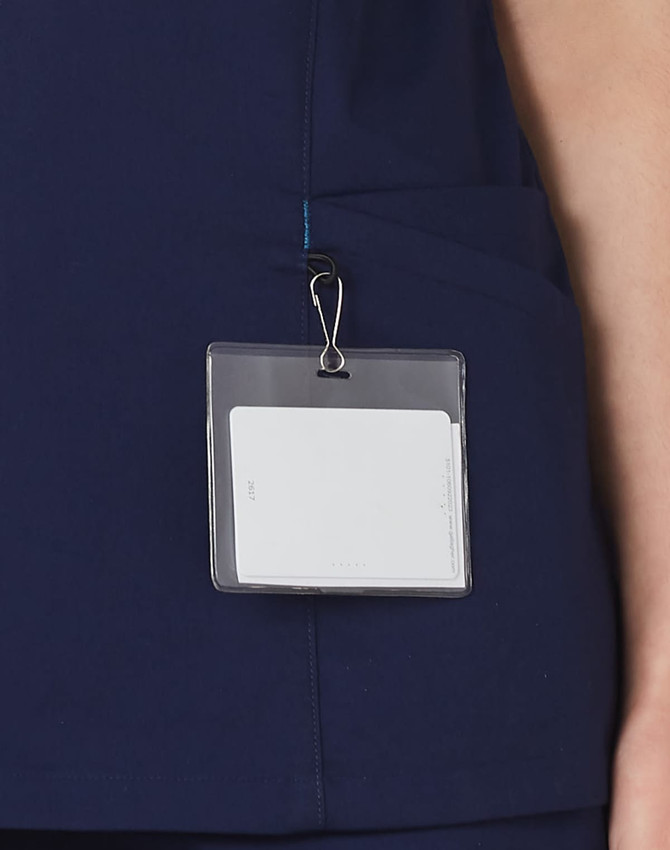 A navy scrub top with a pocket and a badge holder attached.