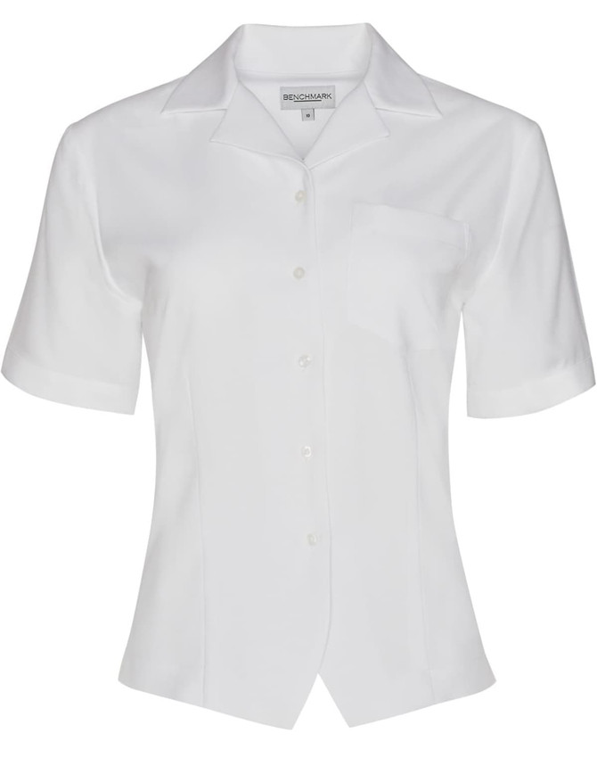 A white women's short sleeve overblouse with a button front and a pocket, featuring a logo.