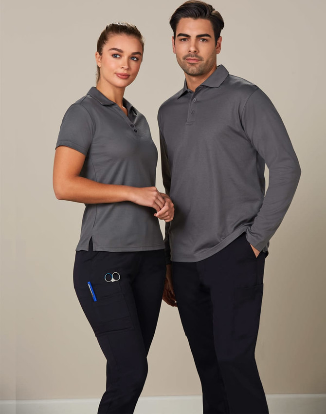 A man and woman wearing grey polo shirts and black cargo pants. The cargo pants have pockets and a logo.