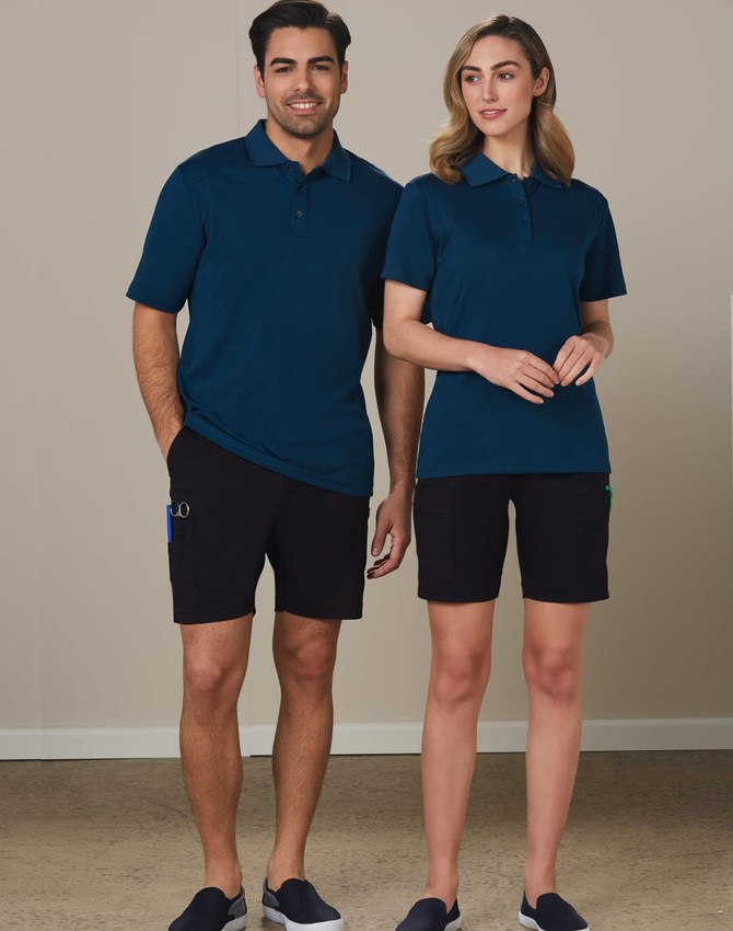 A man and woman wearing navy polo shirts and black cargo shorts, featuring pockets and a logo.