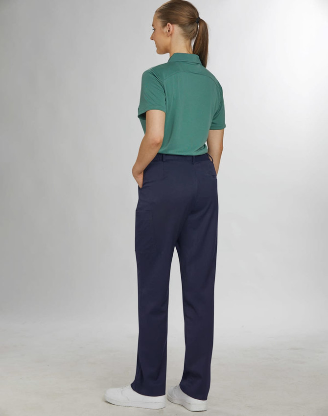 Ladies' utility cargo pants in navy blue, featuring pockets and a tailored fit. Model wears a green polo top.