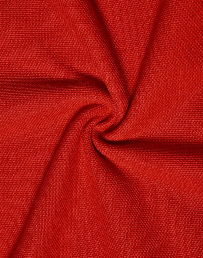 A close-up of red pique knit fabric, showcasing its texture and weave pattern. It features a smooth and breathable surface.