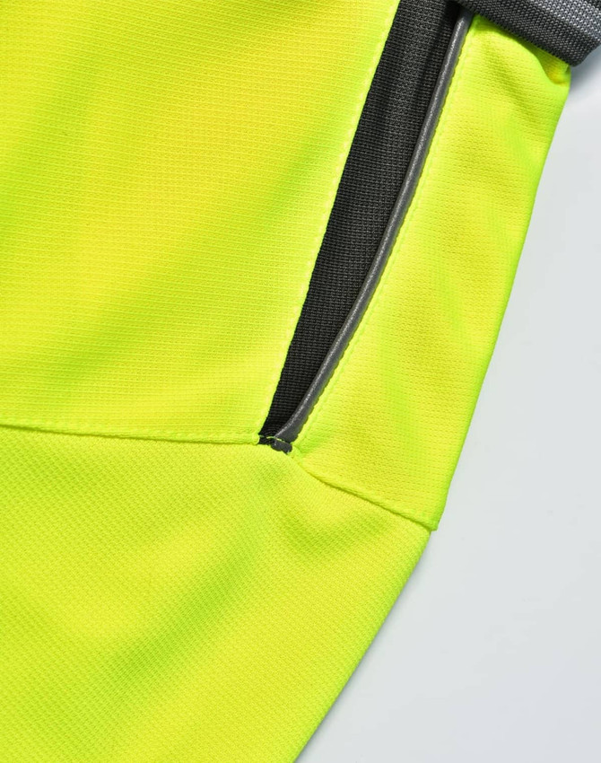 A close-up view of a bright yellow polo shirt featuring a grey accent and a zippered pocket.