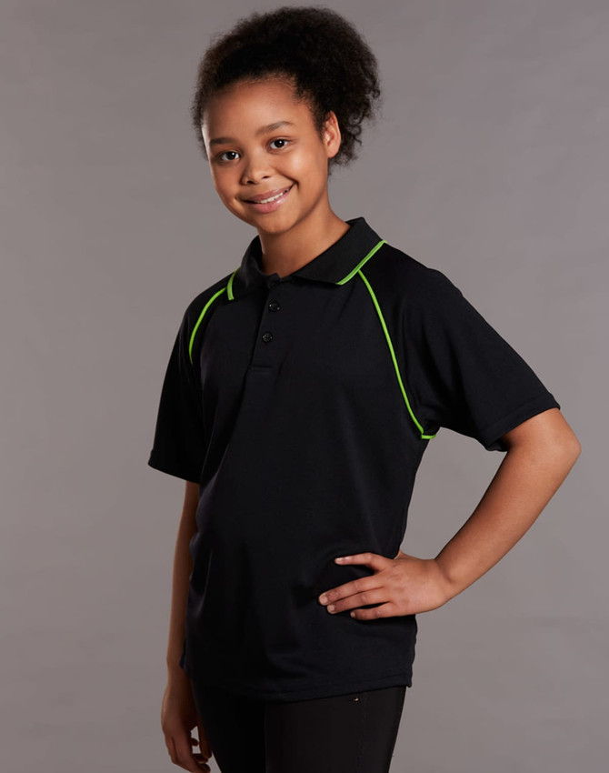 A black polo shirt with green accents, featuring a collar and short sleeves, displayed by a smiling child.