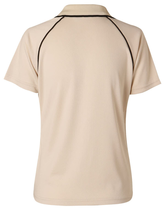 A beige kid's polo shirt with black accents, featuring a classic collar and short sleeves. It has a logo on the back.