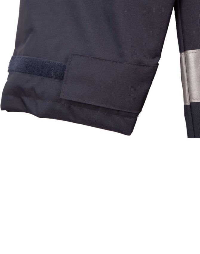 A dark navy safety jacket with reflective 3M tape and a velcro patch on the sleeve. Features branding.