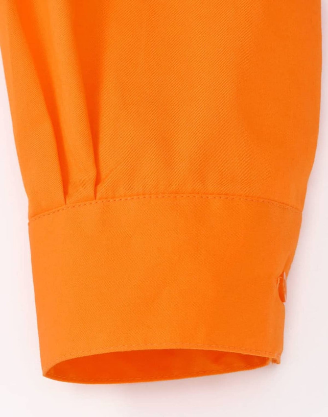 An orange long-sleeved shirt cuff with a button detail, designed for workwear. It features perforated tape.
