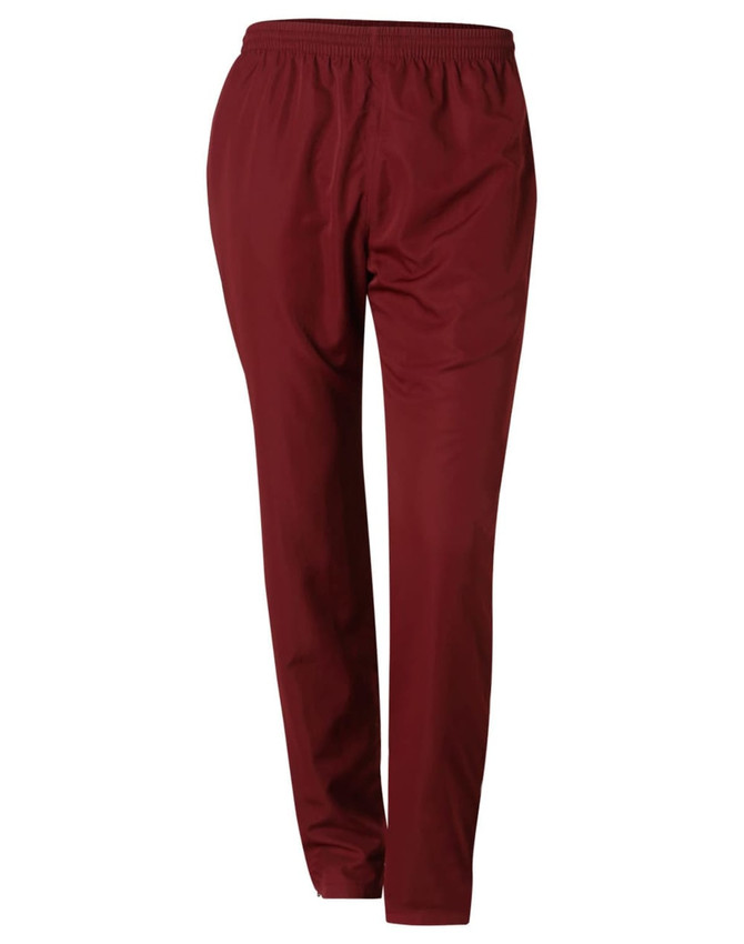Track pants in a deep maroon colour featuring an elastic waistband and a sleek, tapered design. Includes branding.