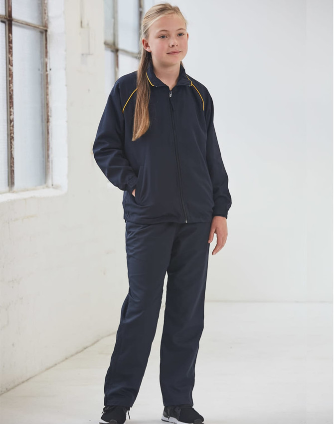 A pair of navy track pants with yellow accents, designed for kids, displayed on a model indoors.