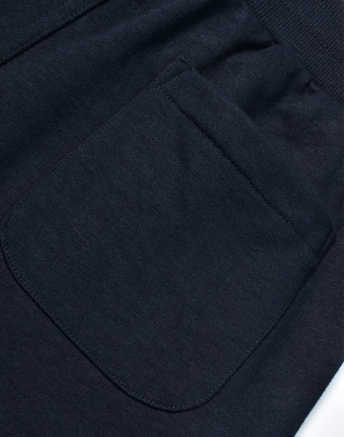 A dark grey pair of poly/cotton terry sweat pants featuring a back pocket. The fabric is soft and textured.