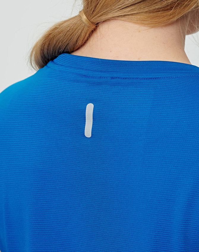 A blue ladies' short-sleeved performance T-shirt featuring a small logo on the back.