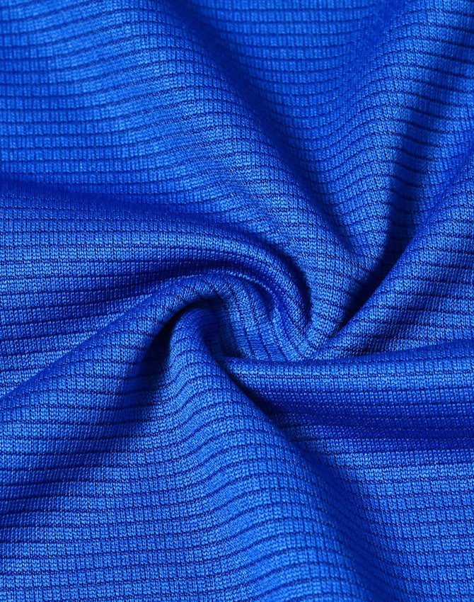 A close-up of blue textured fabric, showcasing a lightweight and performance-oriented material.