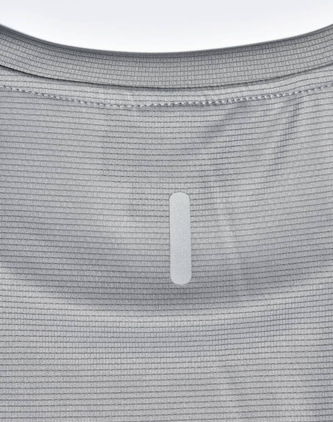 A light grey performance t-shirt featuring a textured pattern and a logo patch on the back.