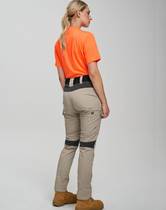 Work pants in beige with navy accents, paired with an orange shirt, displayed from the back. Features a logo.