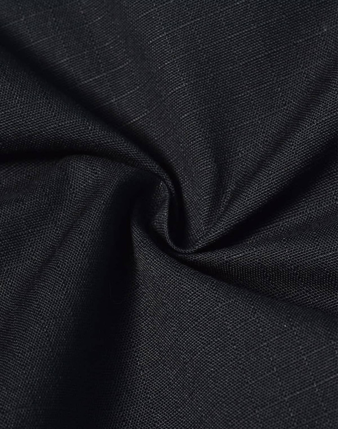 A close-up of black rip-stop poly/cotton fabric, showcasing its textured weave and durable quality.