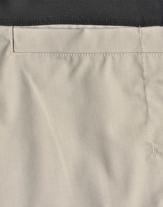 Rip-stop poly/cotton stretch work pants in a light beige colour with a black waistband and stitching details.