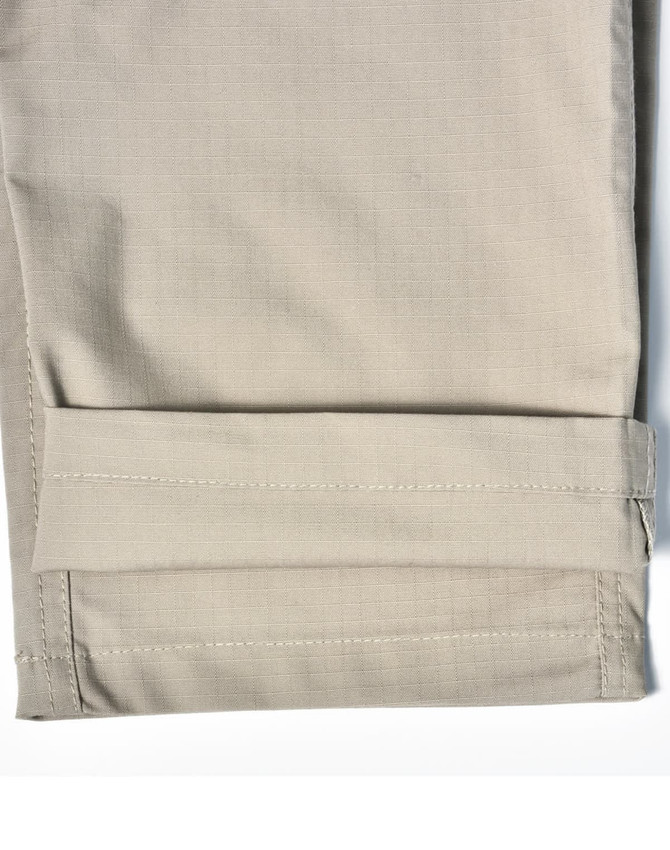 A pair of light khaki Rip-Stop poly/cotton stretch work pants with a cuffed hem. Features a logo.
