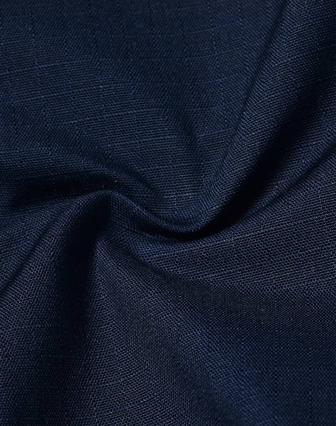 A close-up view of navy rip-stop poly/cotton fabric, showcasing its textured weave and stretch properties.