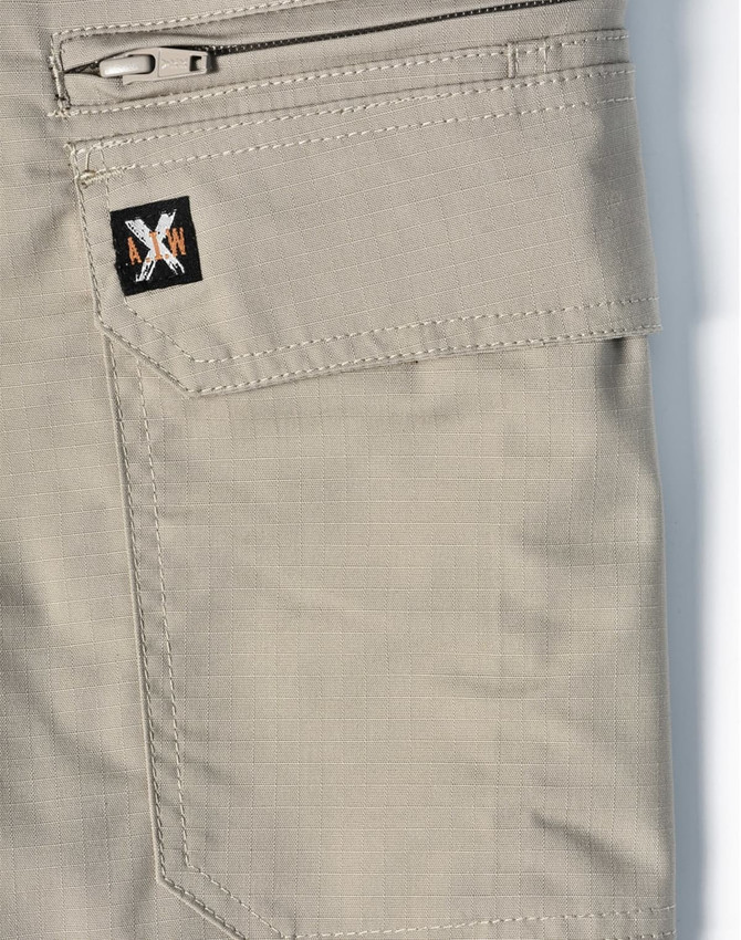 A pair of beige work shorts featuring a zip pocket and a logo patch. The fabric has a rip-stop texture.
