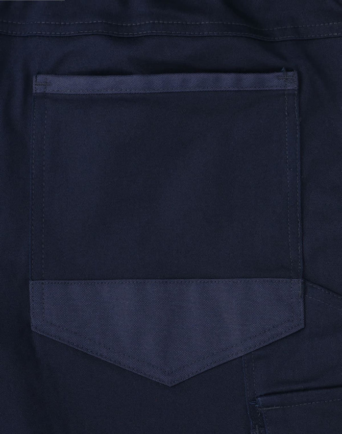 A navy blue fabric with a pocket detail, part of the unisex cotton stretch cuffed work pants.