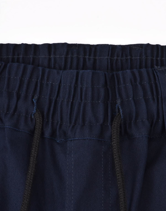 Dark navy unisex cotton stretch drill cuffed work pants with an elastic waistband and drawstring detail.