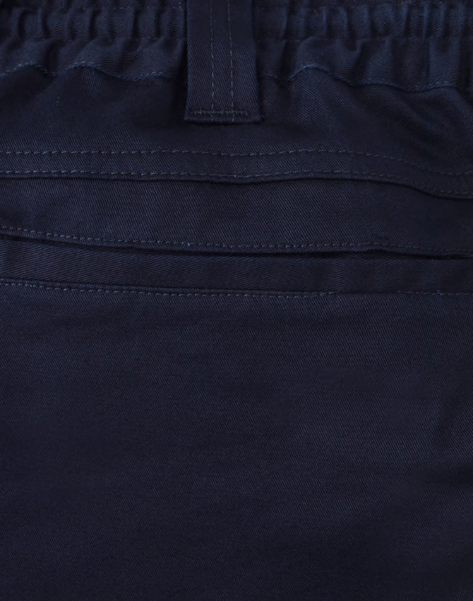 A close-up of navy unisex cotton stretch drill work shorts, featuring an elastic waistband and stitching details.