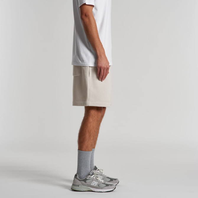 Relax Track Shorts in light beige, featuring a simple design and a logo. Worn with a white top and grey sneakers.