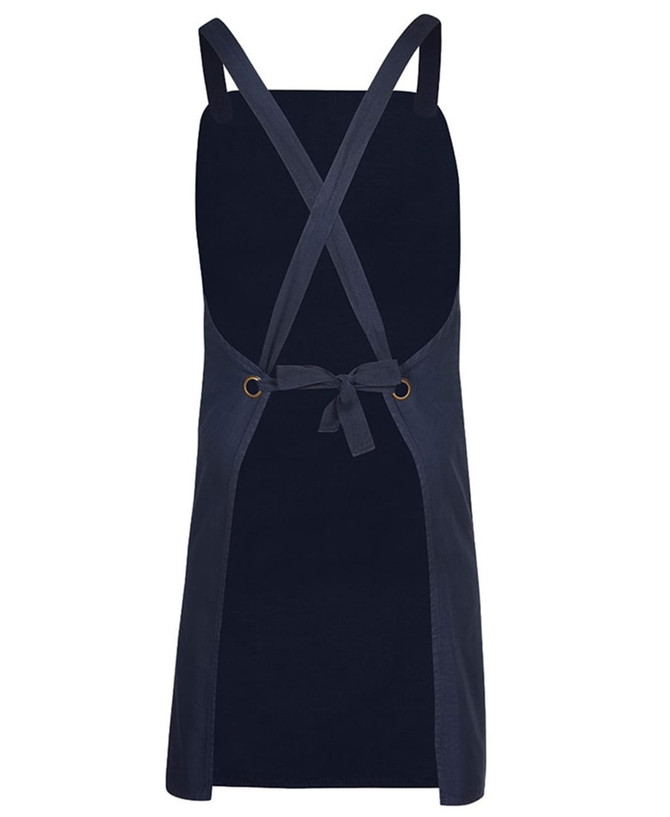 A navy canvas apron with cross back straps and a tie waist, featuring a simple design and a logo.