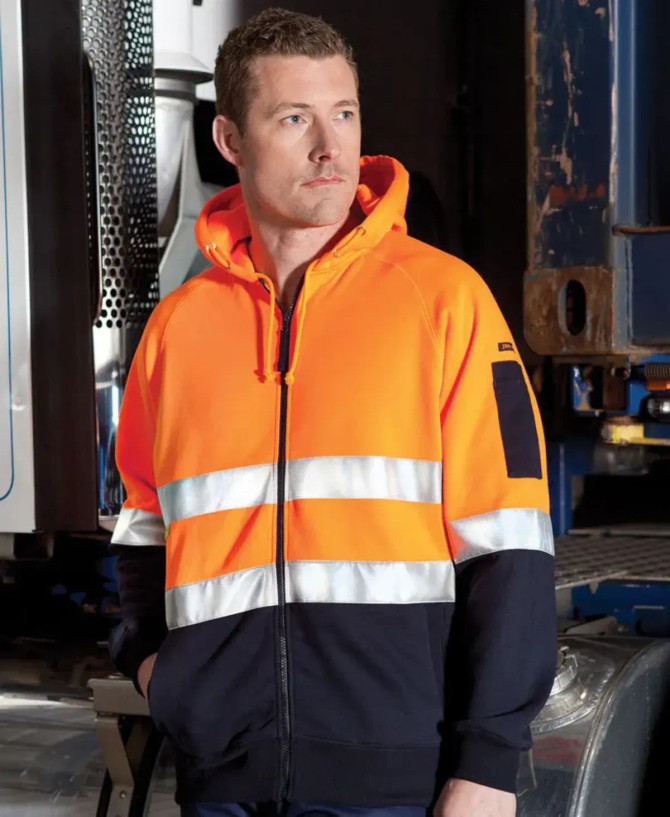 A bright orange and navy full zip fleecy hoodie featuring reflective stripes and a logo on the sleeve.