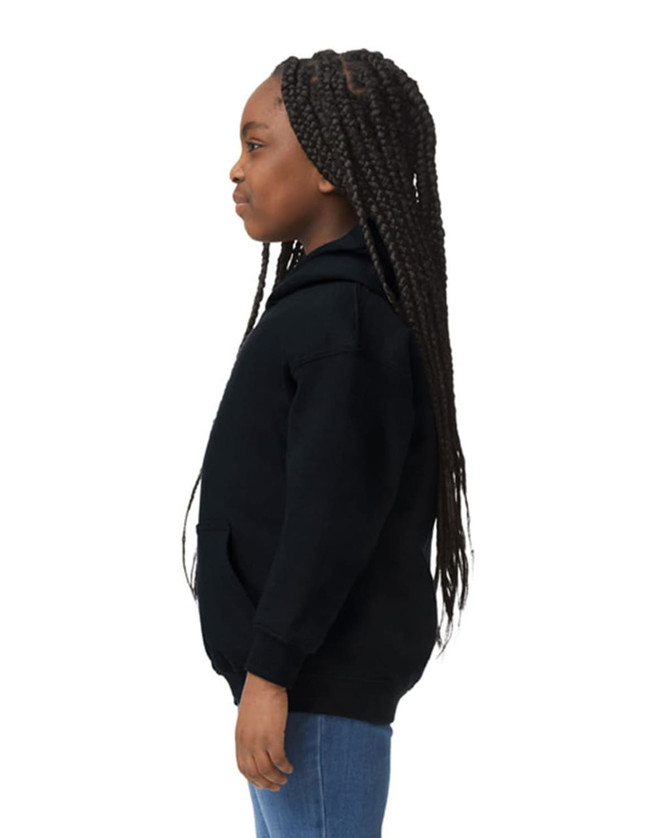 A black Gildan Heavy Blend youth hooded sweatshirt displayed on a child from the side, featuring a hood and pockets.