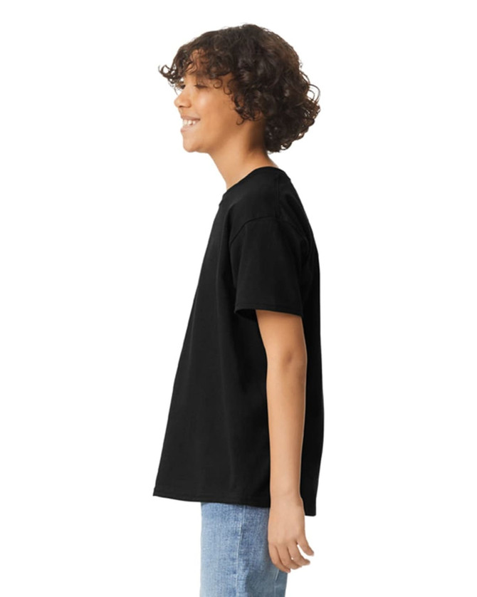 A black youth short sleeve T-shirt displayed on a person from the side, featuring a plain design and a logo.