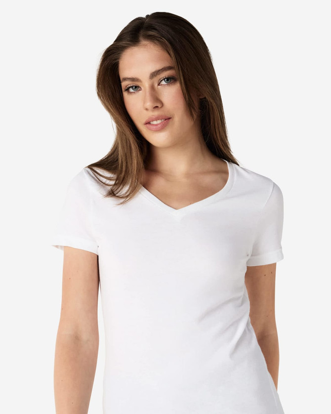 A white Gildan Softstyle ladies' v-neck t-shirt displayed on a model, featuring a fitted design and short sleeves.