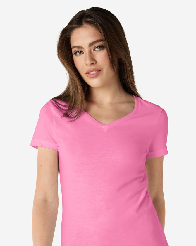 A pink Gildan Softstyle ladies' V-neck T-shirt displayed on a model, featuring a fitted design.