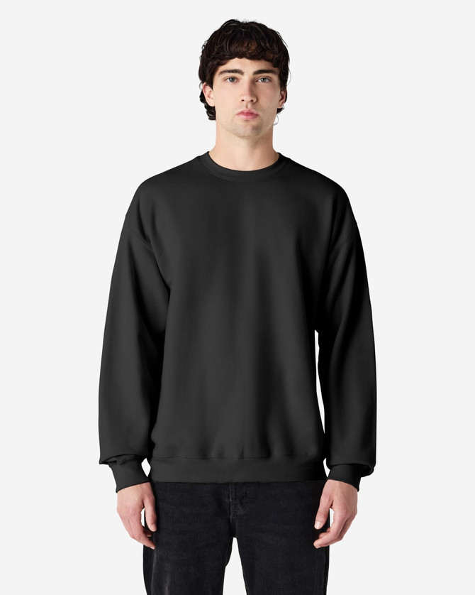 A black Gildan Softstyle adult sweatshirt being worn by a male model. The sweatshirt features a simple design and has a logo.