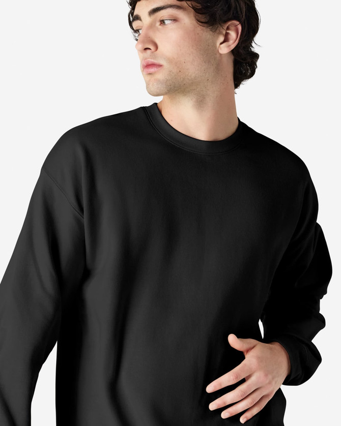 A black Gildan Softstyle adult sweatshirt displayed on a model, featuring a simple design and round neckline.