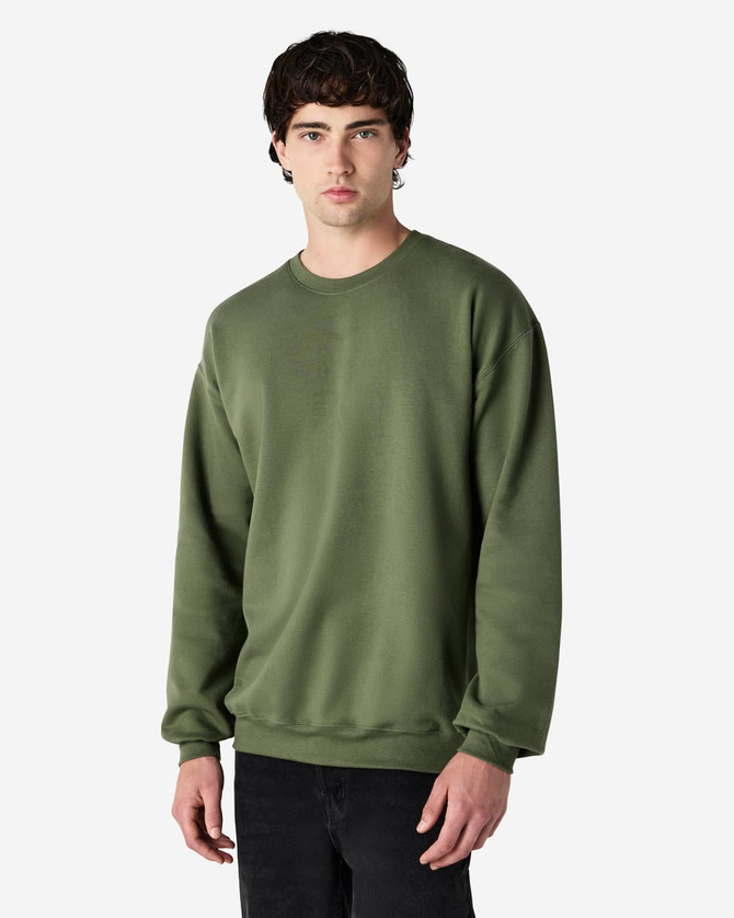 A green Gildan Softstyle adult sweatshirt is displayed on a model, featuring a simple design and a logo.