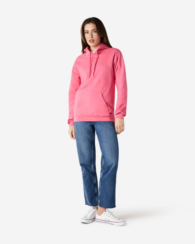 A pink hooded sweatshirt featuring a front pocket, paired with blue jeans and white sneakers.