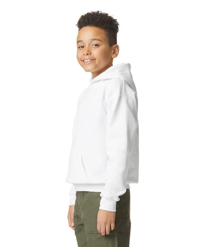 A youth in a white hooded sweatshirt smiles, showcasing the side view of the garment. It features a logo.