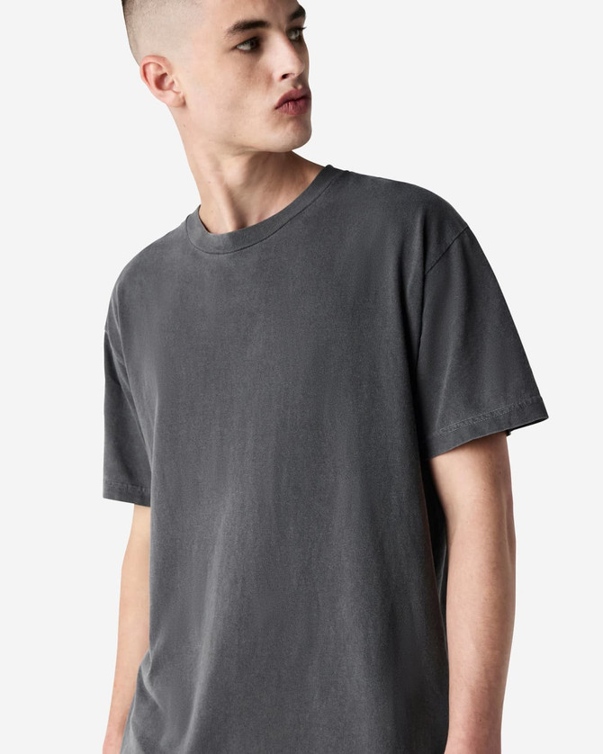 A grey unisex garment-dyed heavyweight cotton T-shirt with a relaxed fit and short sleeves, featuring a logo.