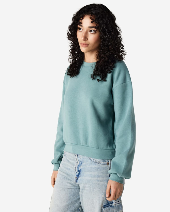 A teal women's crewneck sweatshirt with a relaxed fit and long sleeves, featuring a subtle logo.