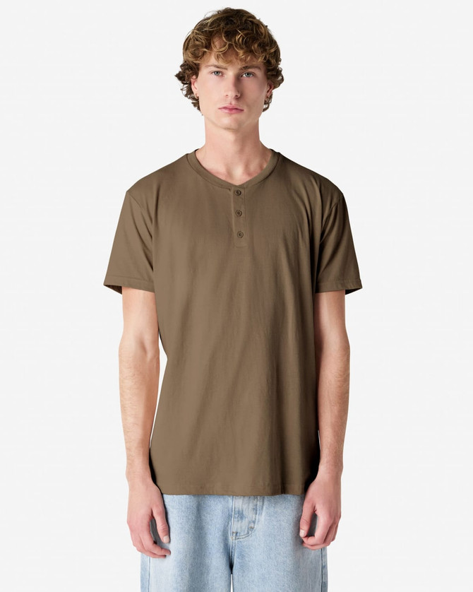 A unisex henley t-shirt in a khaki colour, featuring a round neckline and buttons, displayed on a model.