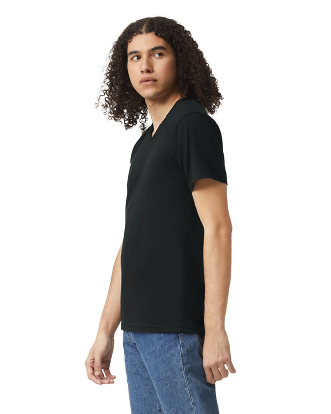 A black unisex V-neck T-shirt displayed on a model standing sideways, featuring a logo.