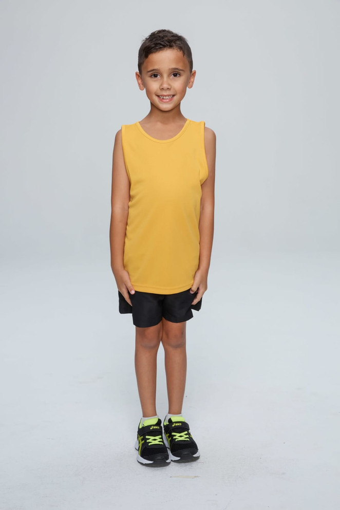A child stands wearing a bright yellow singlet and black shorts, paired with black shoes featuring green accents.